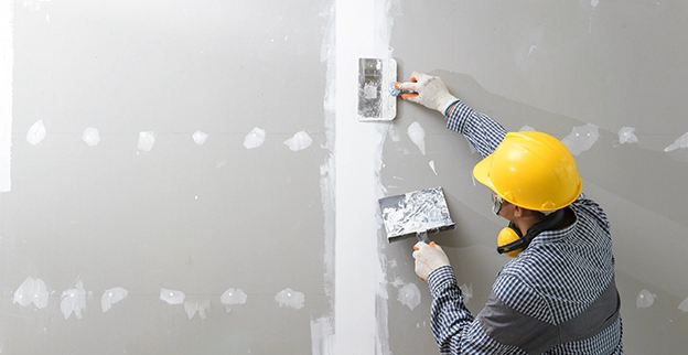 Taping and floating a drywall seam with a knife and mud pan